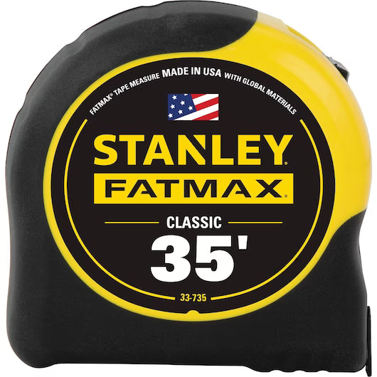The STANLEY® FATMAX® 35 ft Tape features a durable black and yellow case with BladeArmor® coating. Its label reads STANLEY FATMAX CLASSIC 35 and shows an American flag, signifying its USA-made quality.